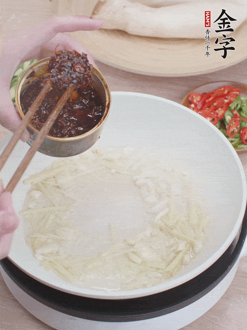 起鍋熱油，姜蒜、金字火腿干貝醬煸香。